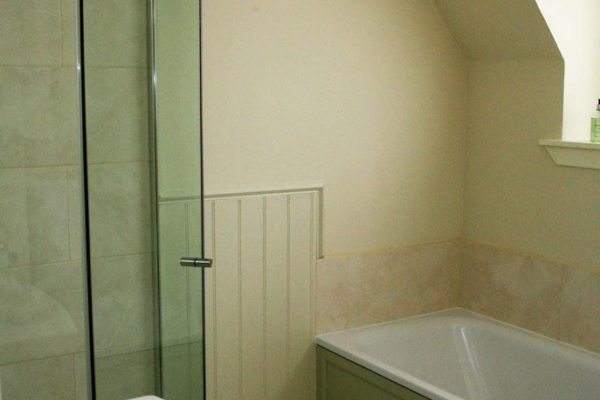 Clean modern bathroom with shower and bath facilities