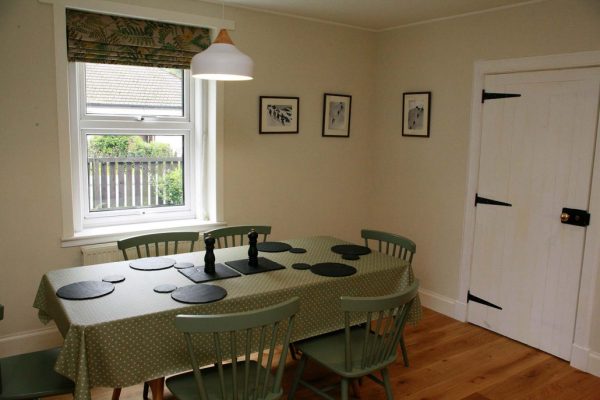 Fully equipped open plan kitchen and dining table setup for 6 guests