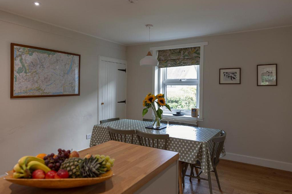 Fully equipped open plan kitchen and dining table setup for 6 guests