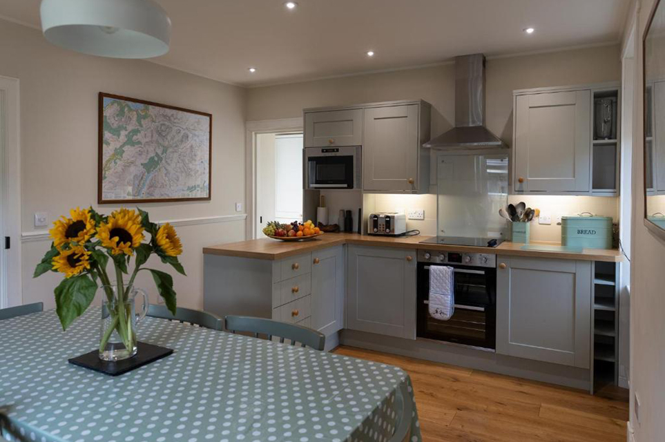 Fully equipped open plan kitchen and dining table setup for 6 guests