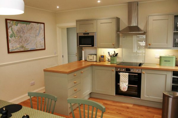 Fully equipped open plan kitchen and dining table setup for 6 guests
