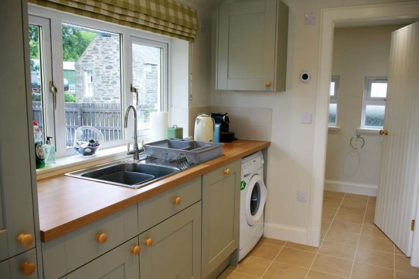 Fully equipped open plan kitchen and dining table setup for 6 guests
